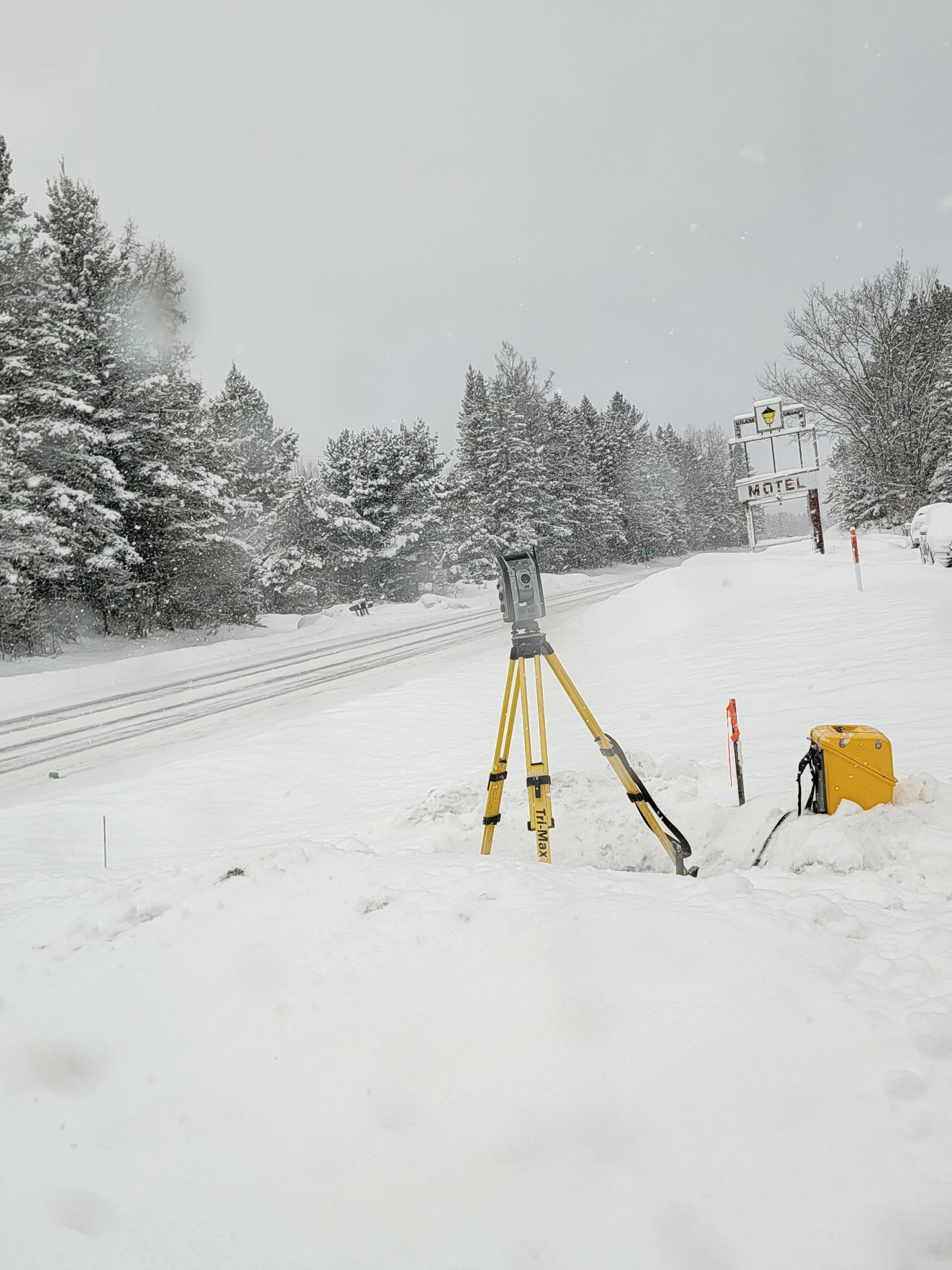 Surveying equipment by side of road in winter Surveying equipment by side of road in winter