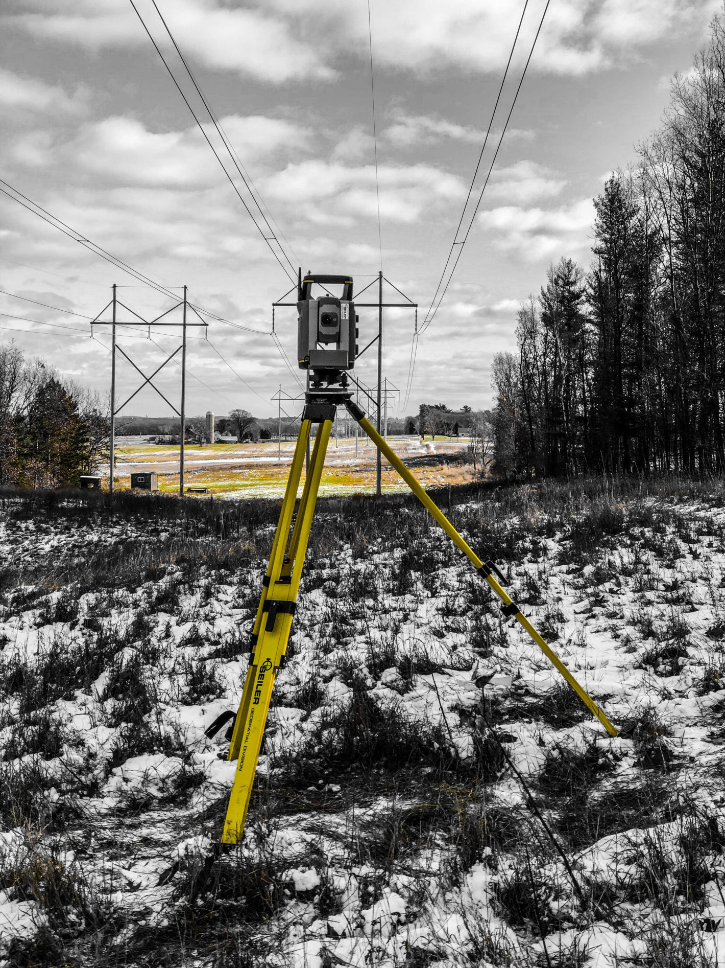 robot total survey station under power lines in winter robot total survey station under power lines in winter